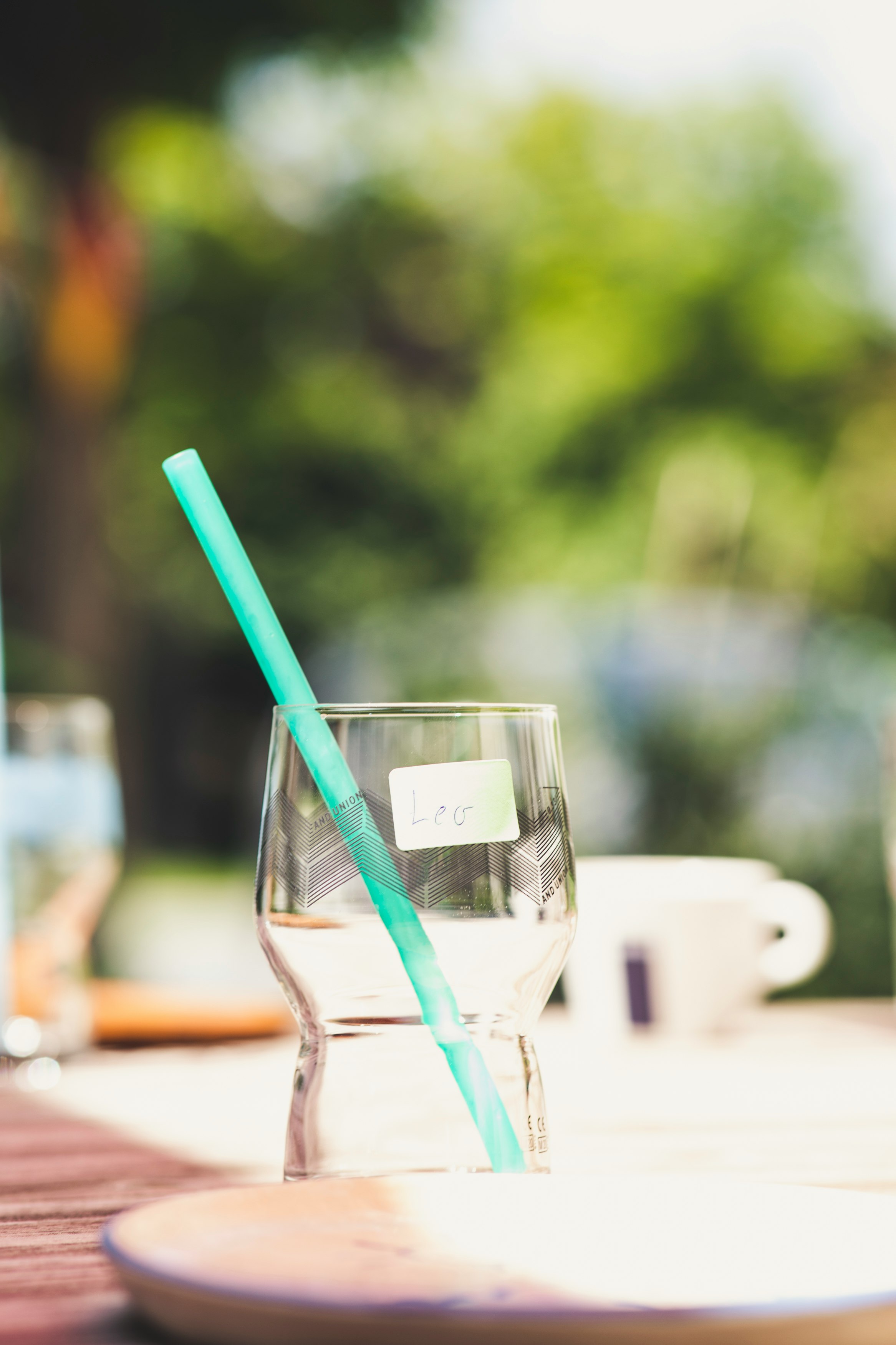 clear drinking glass with blue straw